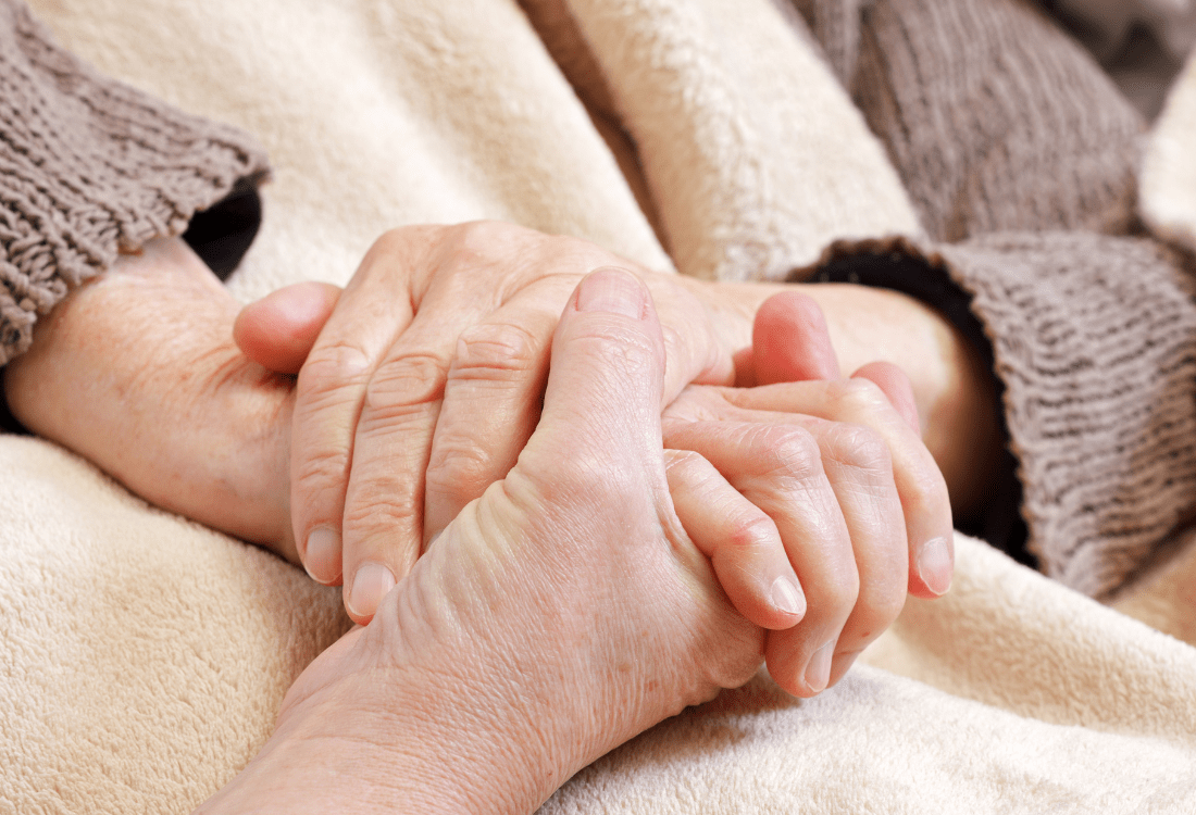 An elderly person being comforted by their family after contracting a virus through improper usage of soluble laundry bags in their care home. 