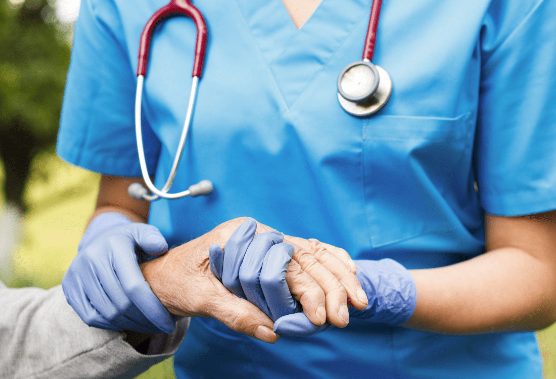 A care home nurse helping an elderly person knowing infections will not be spread due to the safe use of alginate laundry bags.